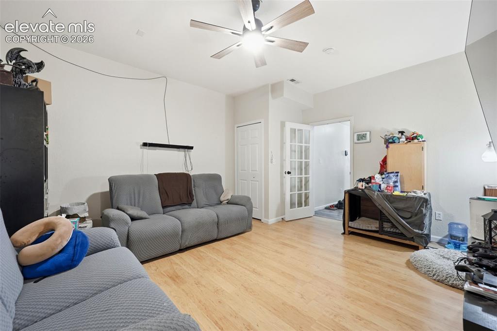 Image 30 of 49: Living area featuring wood-finish flooring, light-colored walls, and a ceil