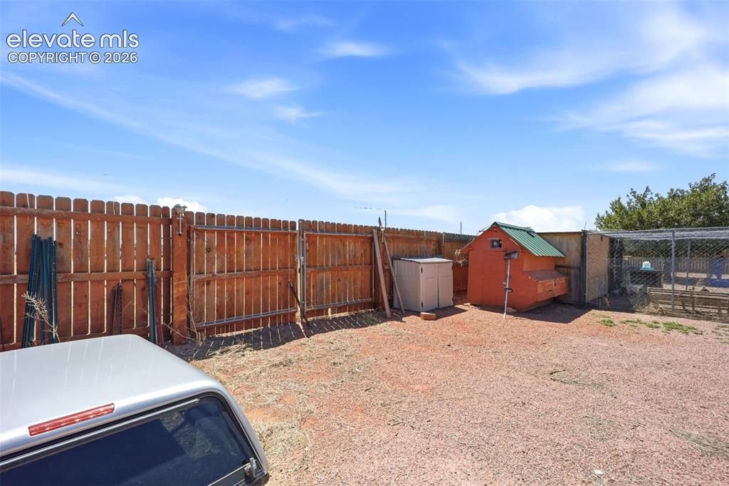 Image 37 of 49: Enclosed backyard with a full wood privacy fence and gate access