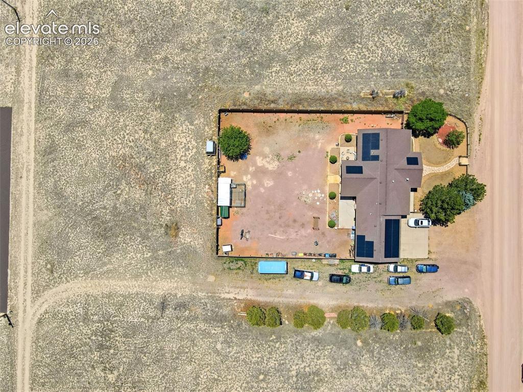 Image 48 of 49: Expansive property featuring a central residence with a brown shingle roof