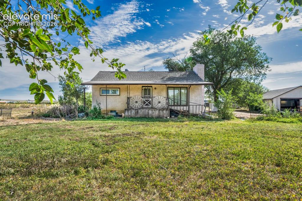 Caption: Ranch-style home with covered porch and fireplace in the living room. 