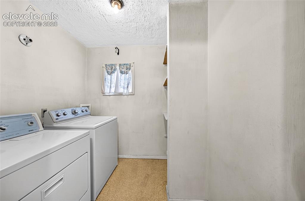 Image 17 of 45: Laundry area featuring a window, and wall-mounted shelving