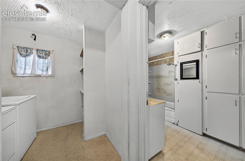 Image 18 of 45: Laundry room and bathroom next to each other