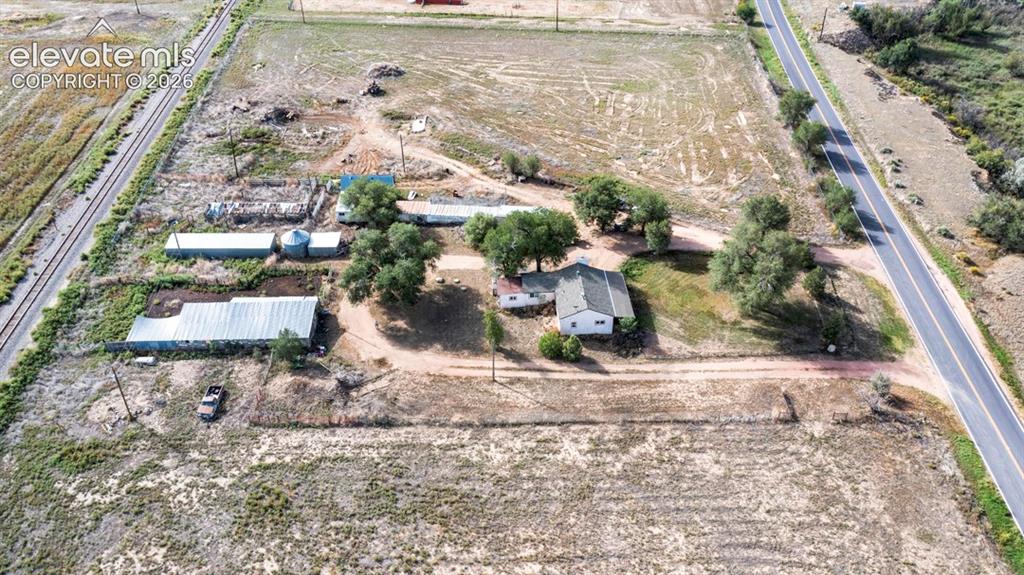 Image 45 of 45: Expansive land parcel featuring multiple outbuildings, a detached dwelling 