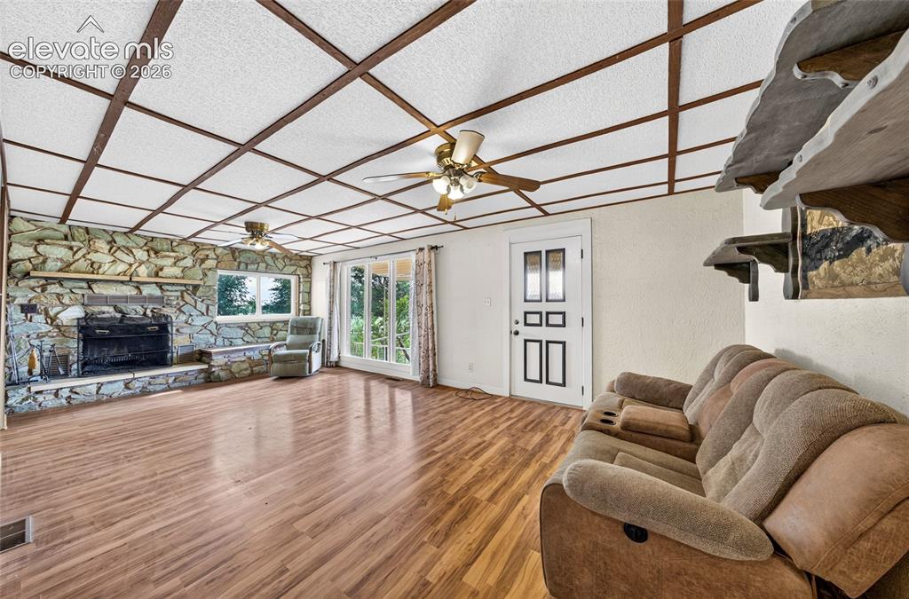 Image 6 of 45: Spacious living room with a cozy fireplace. 