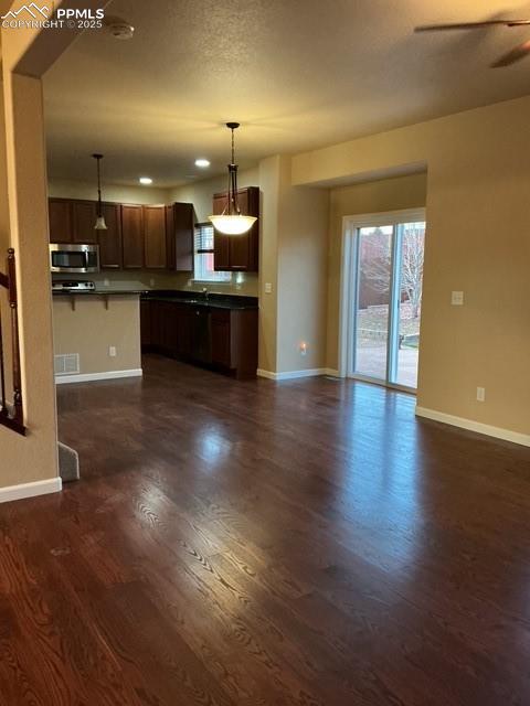 Image 11 of 29: living room featuring dark wood-type flooring, a textured ceiling, and cei