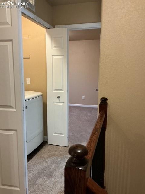 Image 17 of 29: Upstairs hallway; featuring washer / dryer