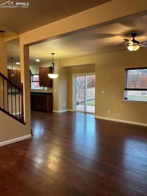 Image 9 of 29: View from front door into living room featuring a ceiling fan, natural ligh