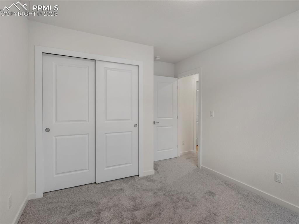 Image 26 of 32: Unfurnished bedroom with light carpet and a closet
