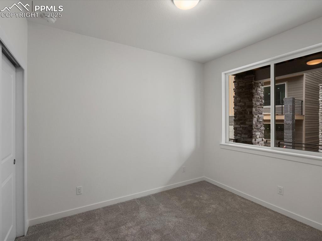 Image 28 of 32: Unfurnished bedroom featuring carpet floors and a closet