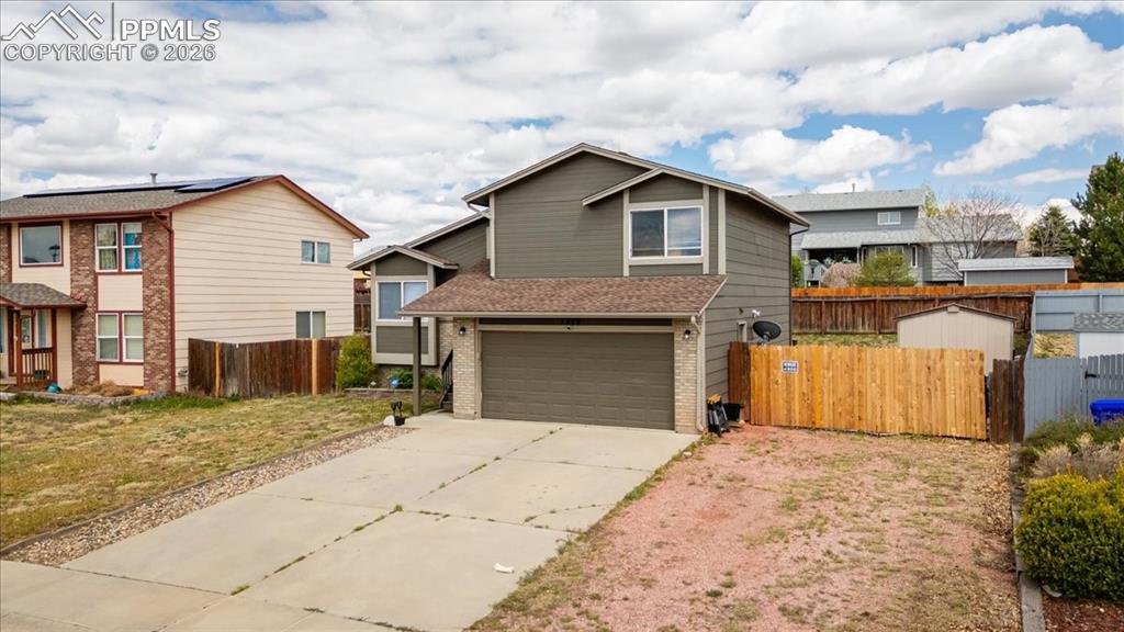 Image 2 of 49: Two-story home with a two-car garage