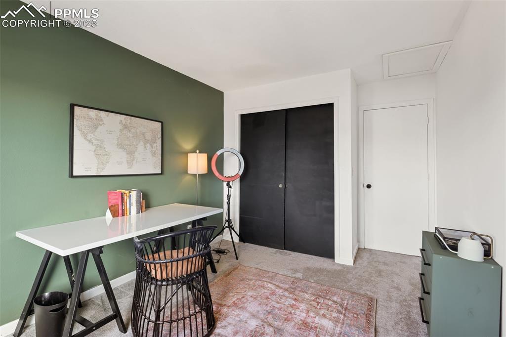 Image 18 of 27: Home office with carpet and attic access
