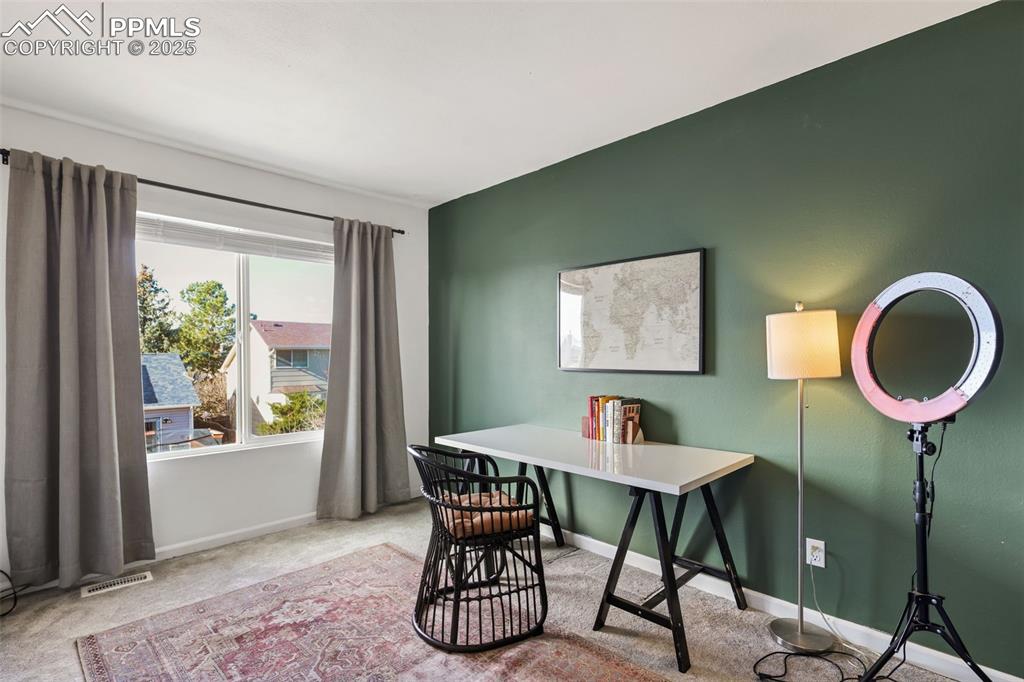 Image 19 of 27: Office area with light colored carpet and baseboards