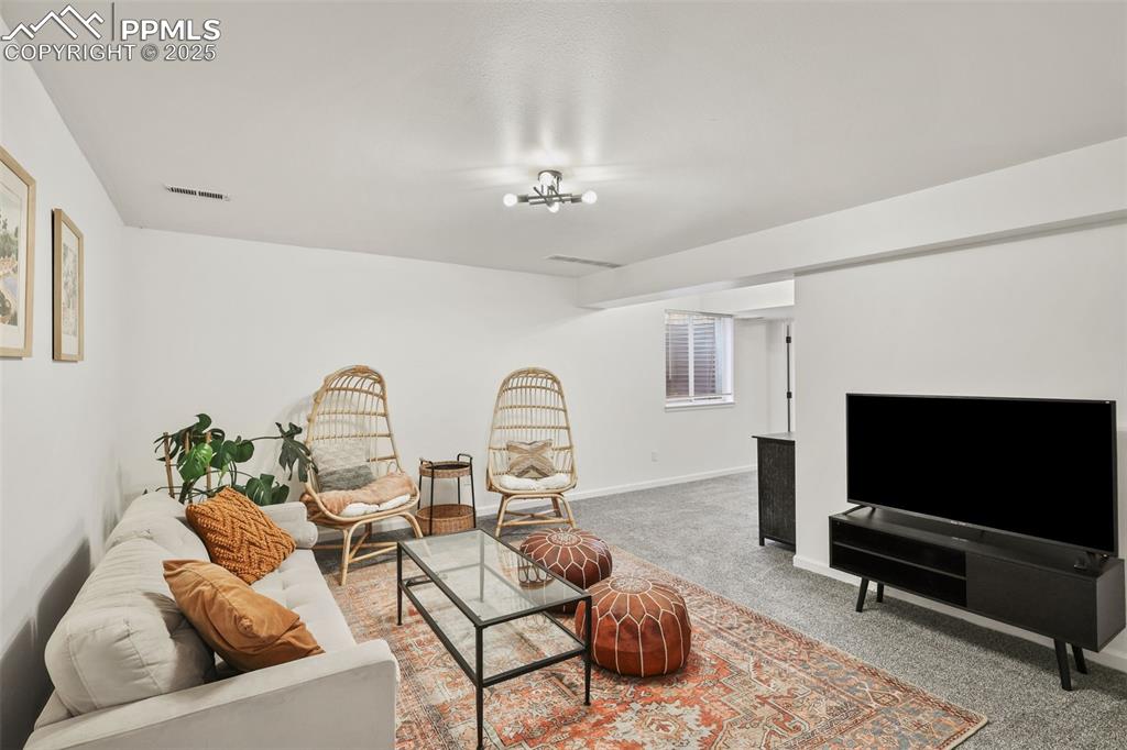 Image 21 of 27: Carpeted living area featuring baseboards