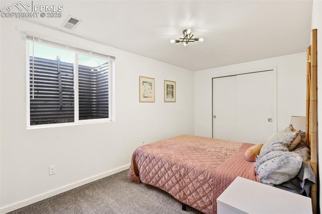 Image 22 of 27: Bedroom featuring a closet and carpet floors