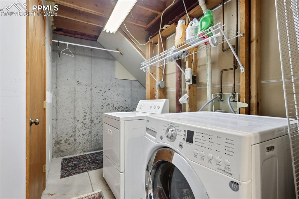 Image 24 of 27: Washroom with washing machine and dryer