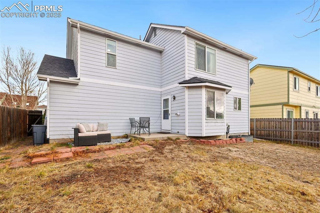 Image 26 of 27: Rear view of property featuring a fenced backyard, a patio, and a shingled 