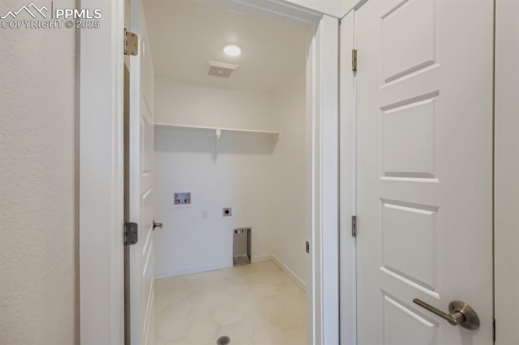 Image 25 of 28: Laundry area with electric dryer hookup and hookup for a washing machine