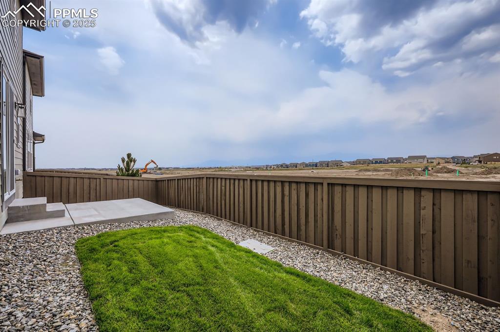 Image 26 of 28: View of fenced backyard
