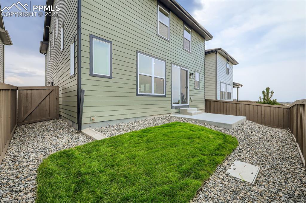 Image 27 of 28: Rear view of property with a patio, a fenced backyard, and a gate