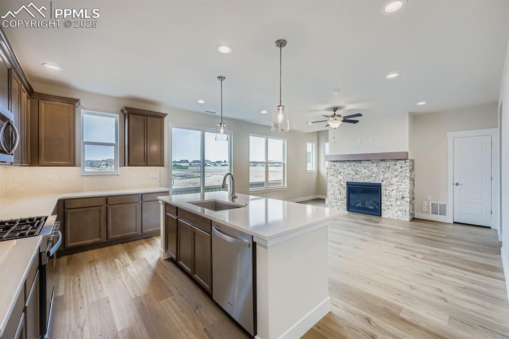 Image 8 of 28: Kitchen featuring tasteful backsplash, recessed lighting, pendant lighting,