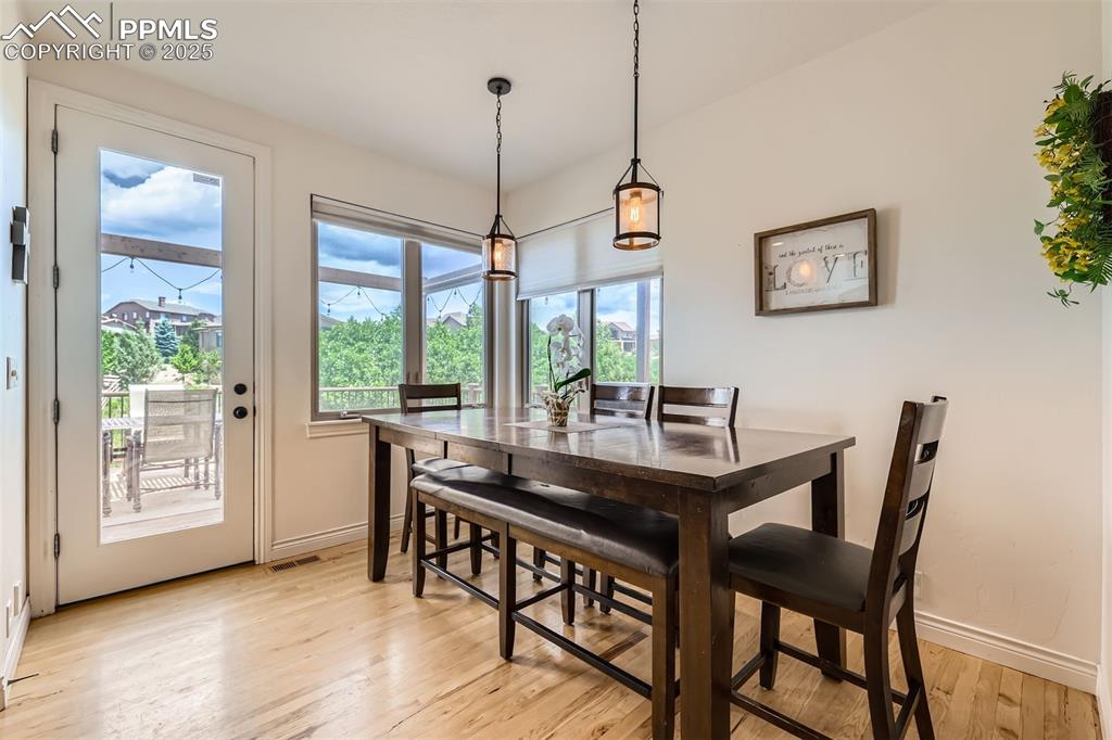 Image 11 of 28: Dining space with light hardwood flooring and baseboards