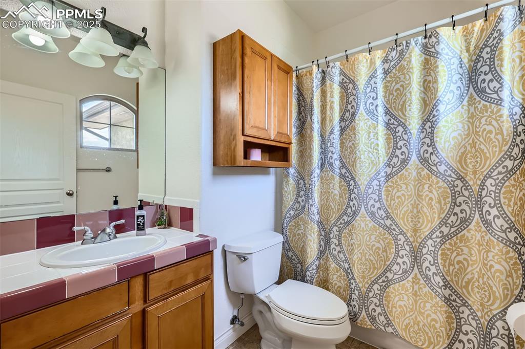 Image 19 of 28: Bathroom featuring vanity and curtained shower