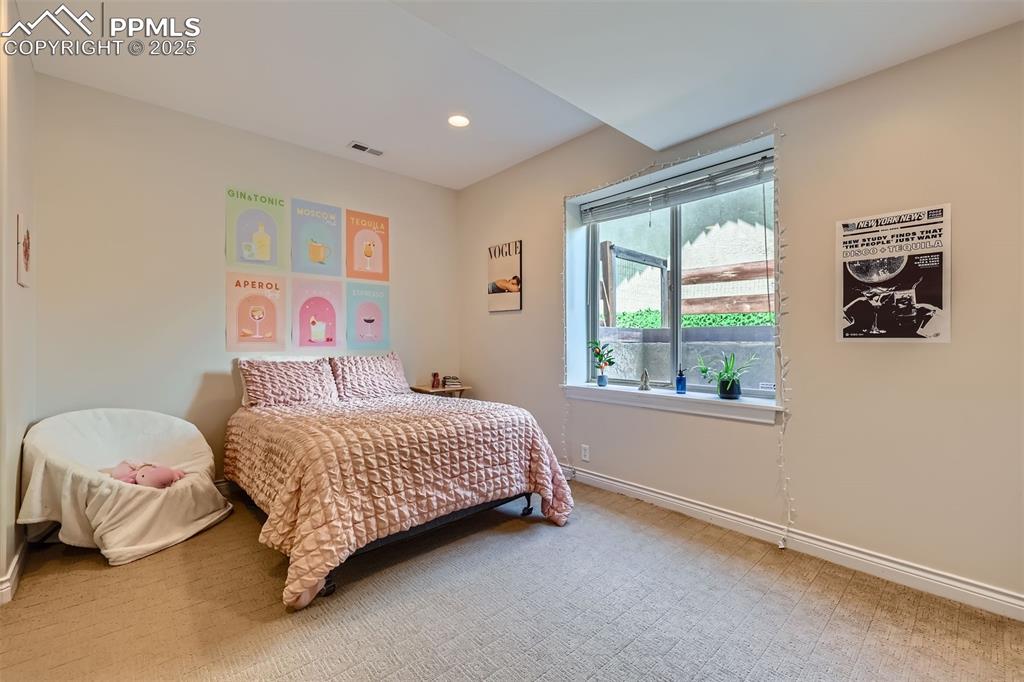Image 21 of 28: Carpeted bedroom with recessed lighting and baseboards