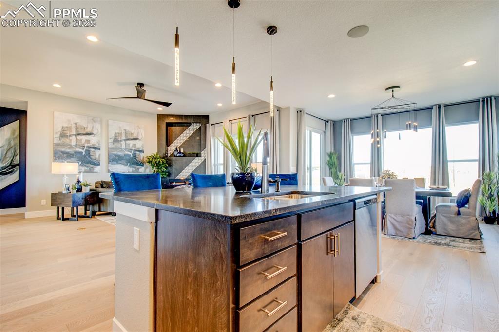 Image 10 of 30: Kitchen featuring open floor plan, light wood-style floors, an island with