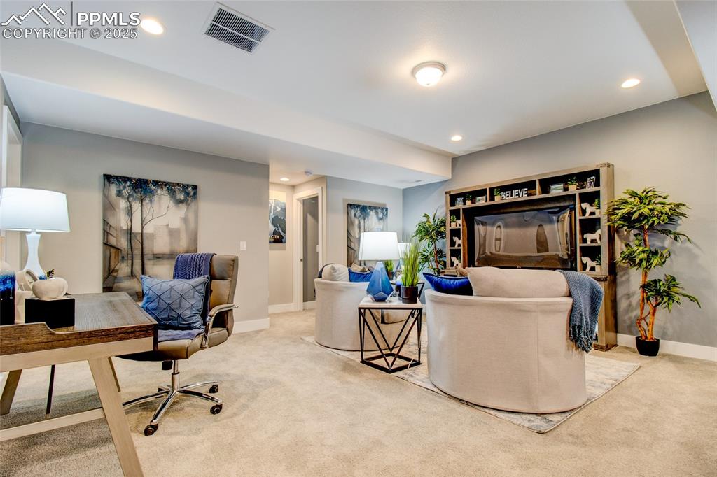 Image 25 of 30: Home office with carpet floors and recessed lighting