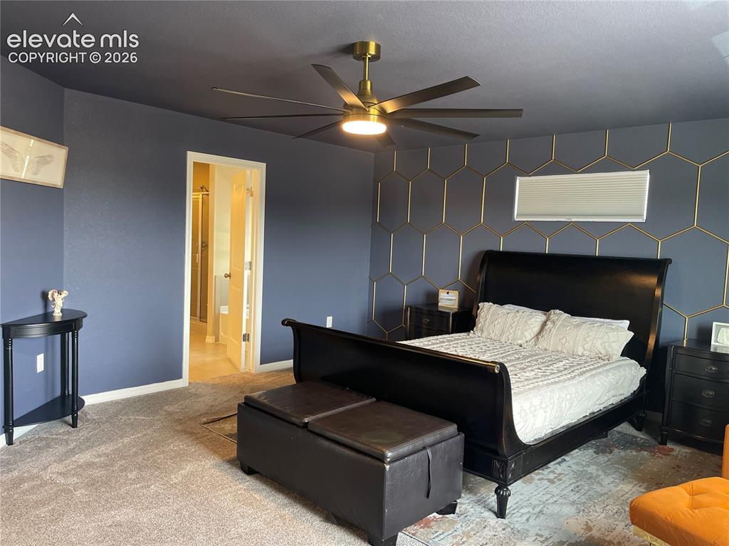 Image 12 of 25: Carpeted bedroom featuring an accent wall and a ceiling fan