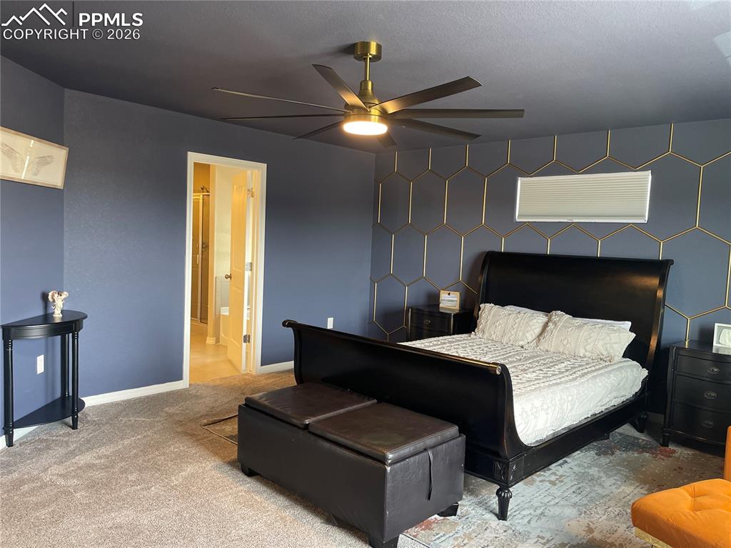Image 13 of 26: Carpeted bedroom featuring an accent wall and a ceiling fan