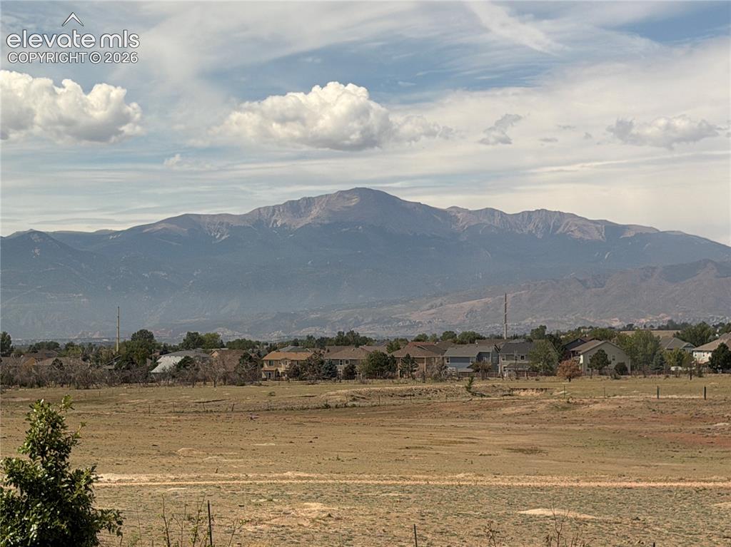 Image 21 of 24: Expansive mountain backdrop with a wide-open foreground