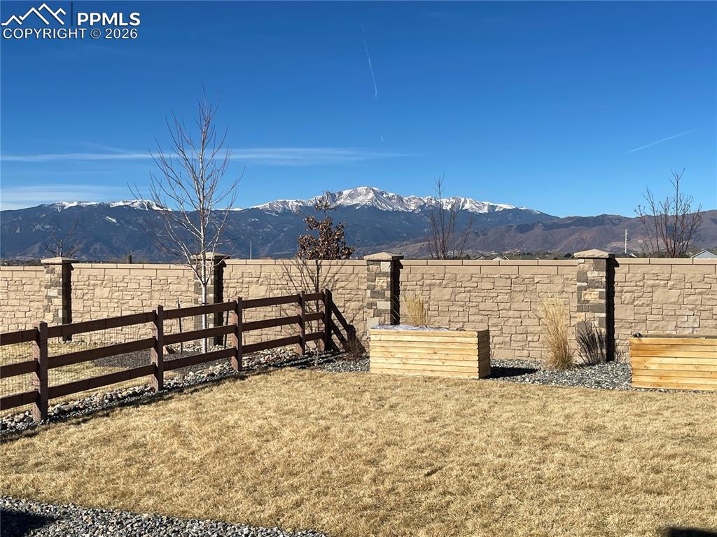 Image 23 of 26: Fenced backyard featuring a mountain view