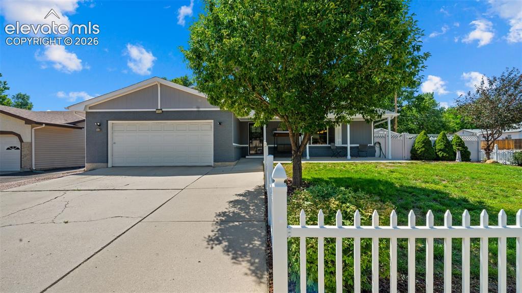 Image 1 of 39: Stucco exterior with a gable roofline, featuring an attached garage with a