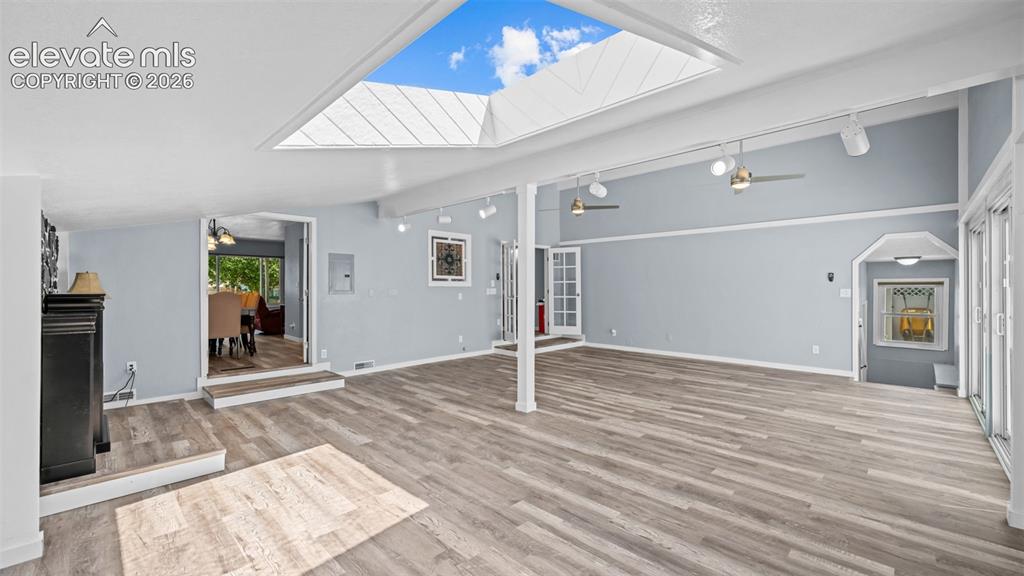 Image 15 of 39: Open-concept living and dining area featuring wood-finish flooring througho