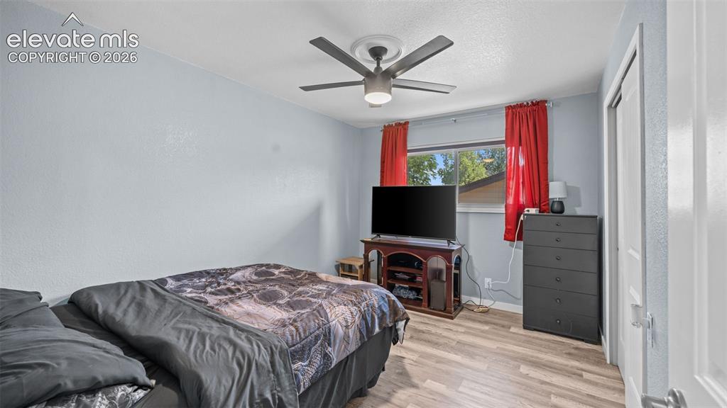 Image 25 of 39: Light blue walls complement wood-finish flooring throughout this living spa