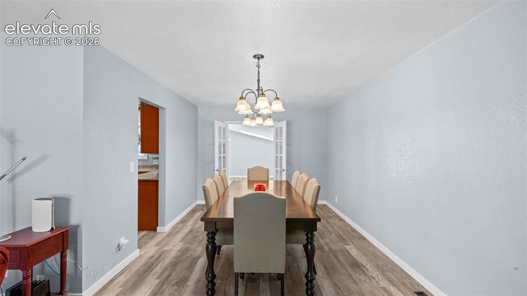 Image 9 of 39: Wood-finish flooring throughout, featuring a light blue wall paint, recesse