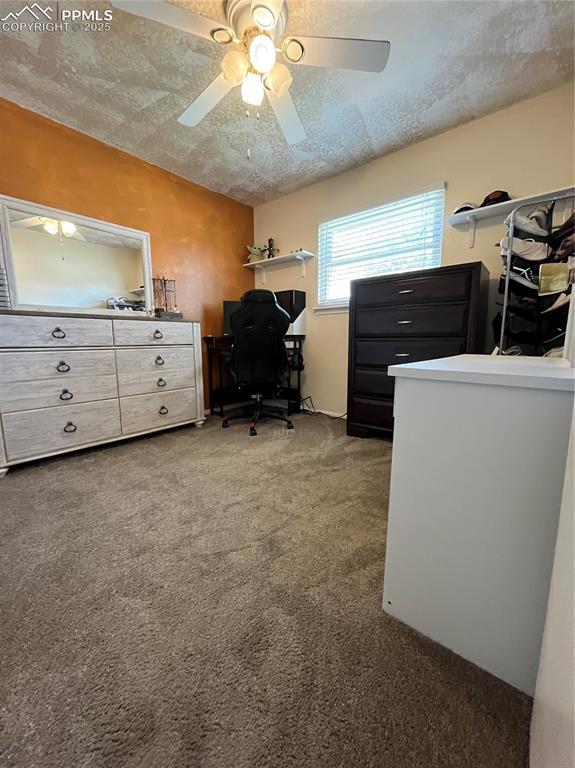 Image 14 of 29: Home office with carpet, a textured ceiling, and ceiling fan