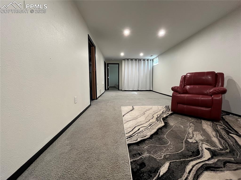 Image 18 of 29: Sitting room featuring baseboards, light colored carpet, and recessed light