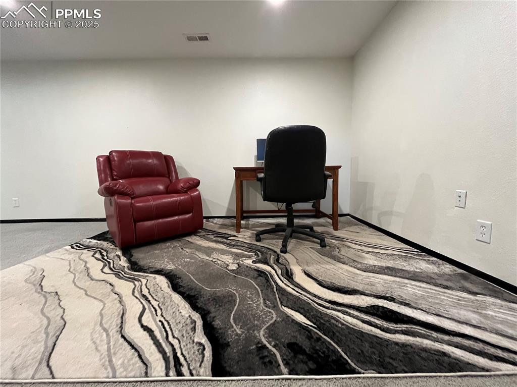 Image 19 of 29: Office area with carpet floors and baseboards