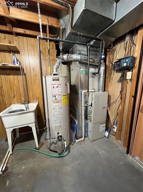 Image 23 of 29: Utilities featuring gas water heater and heating unit