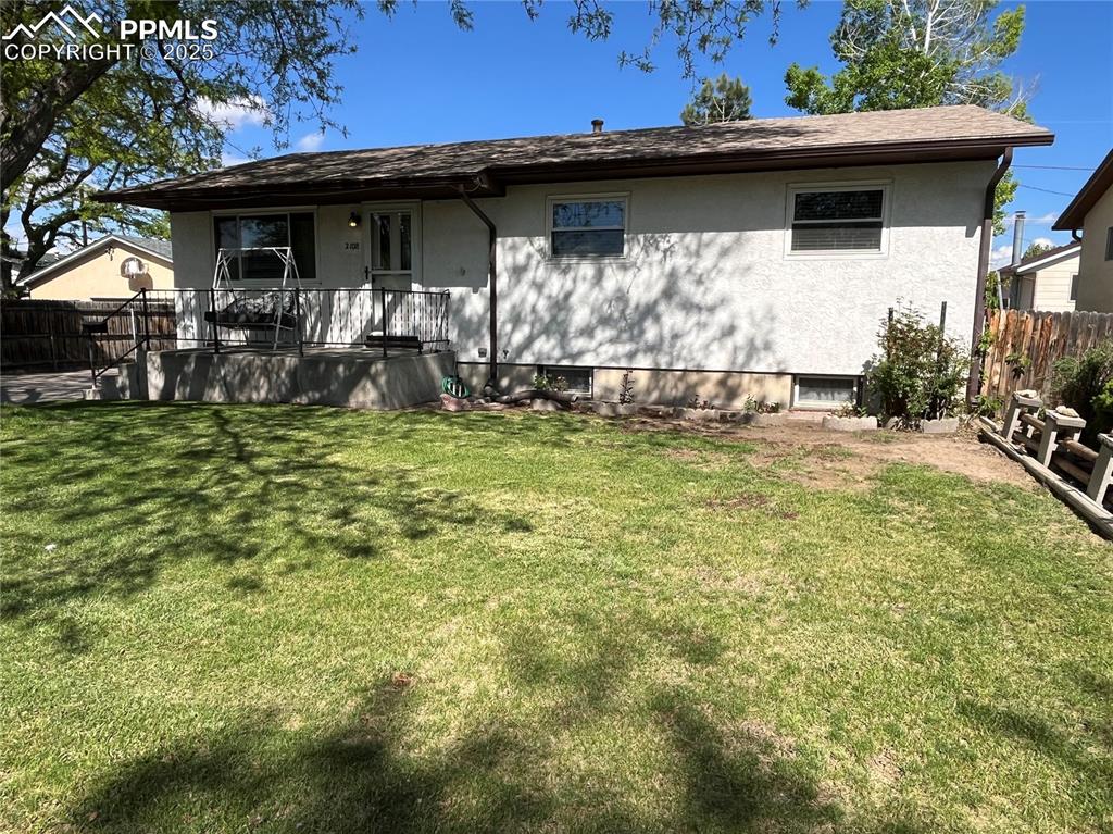 Image 3 of 29: Back of property featuring stucco siding