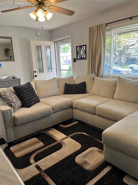 Image 6 of 29: Living area featuring ceiling fan and plenty of natural light