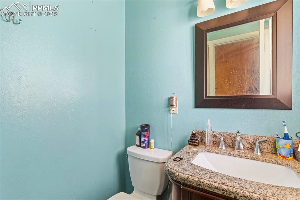 Image 10 of 25: Bathroom featuring vanity and a textured wall