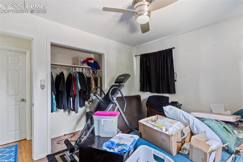 Image 11 of 25: Bedroom with wood finished floors, a closet, and ceiling fan
