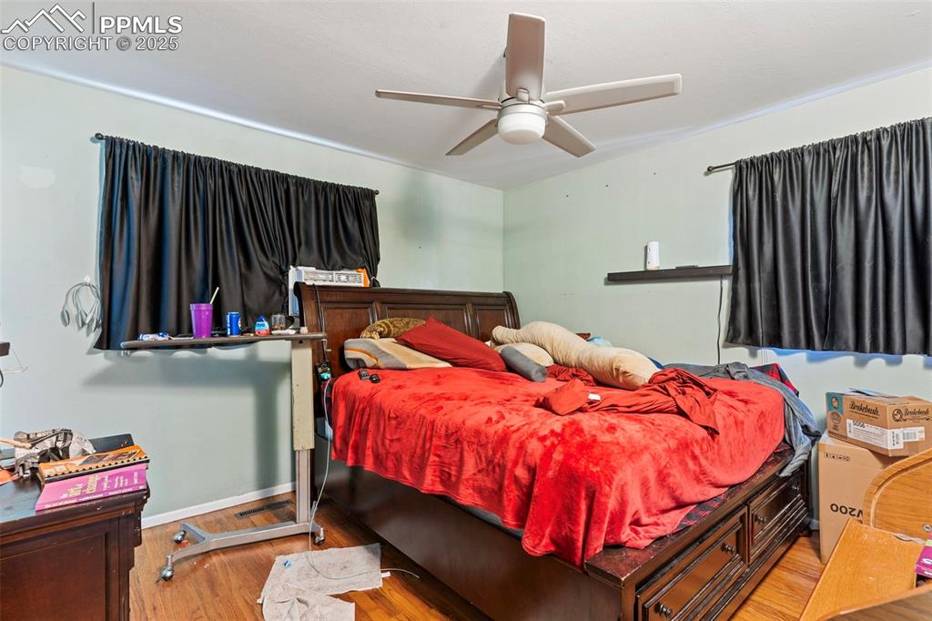 Image 13 of 25: Bedroom featuring wood finished floors and ceiling fan