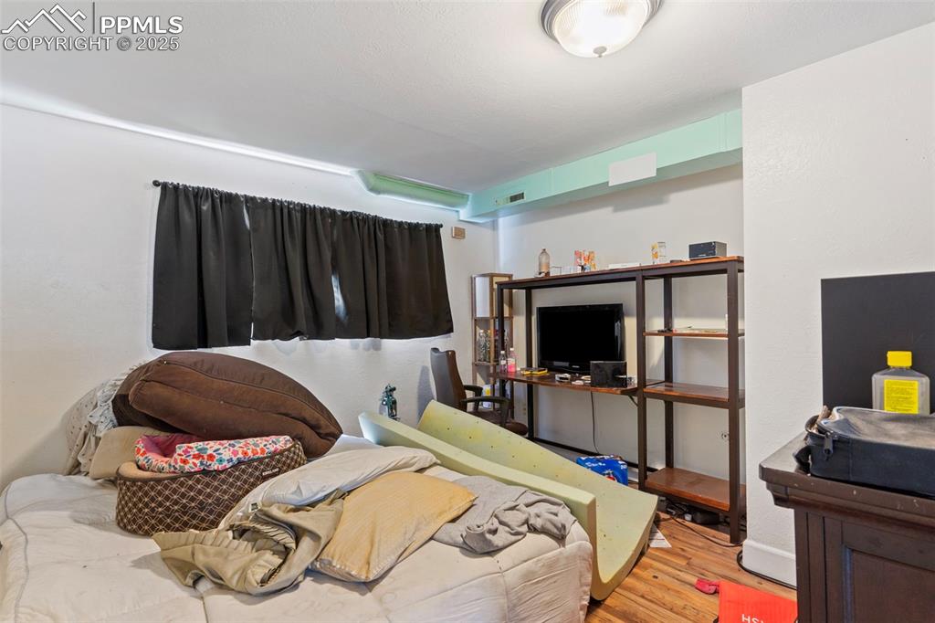 Image 16 of 25: Bedroom featuring wood finished floors