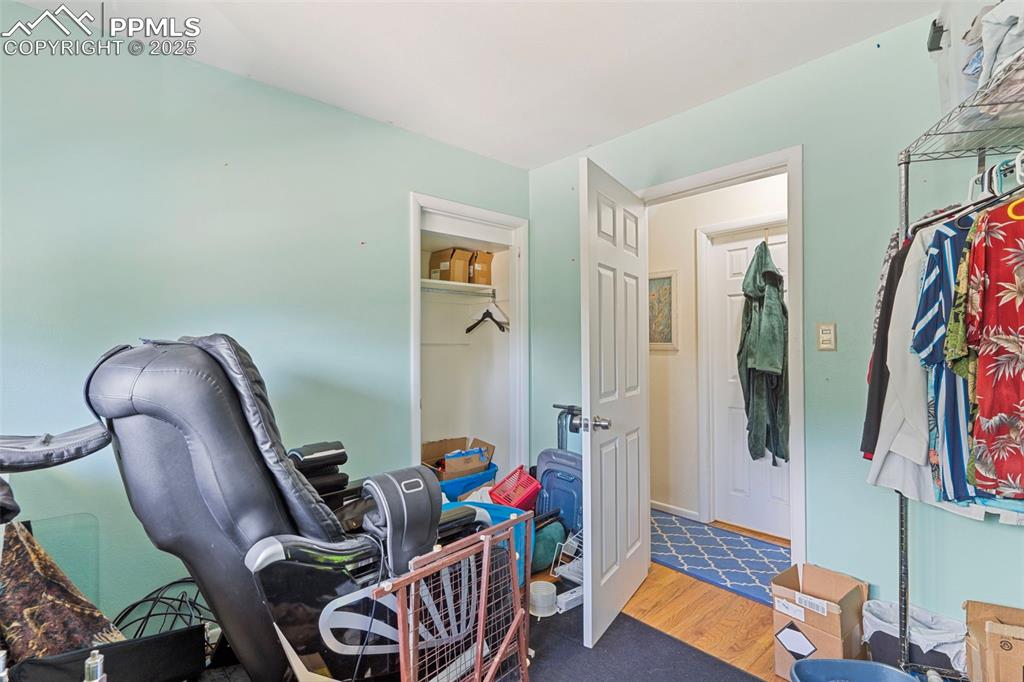 Image 18 of 25: Bedroom with wood finished floors and a closet