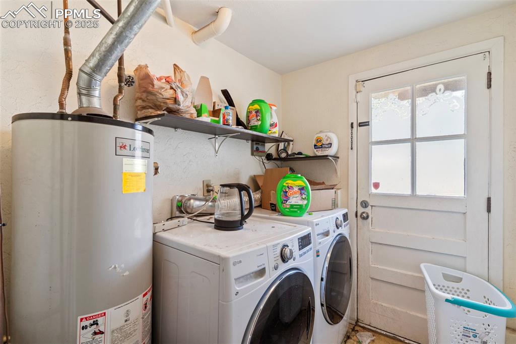 Image 20 of 25: Laundry room with water heater and washer and dryer