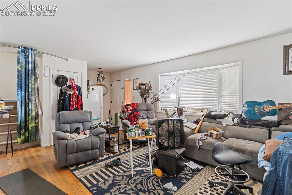 Image 3 of 25: Living room with wood finished floors